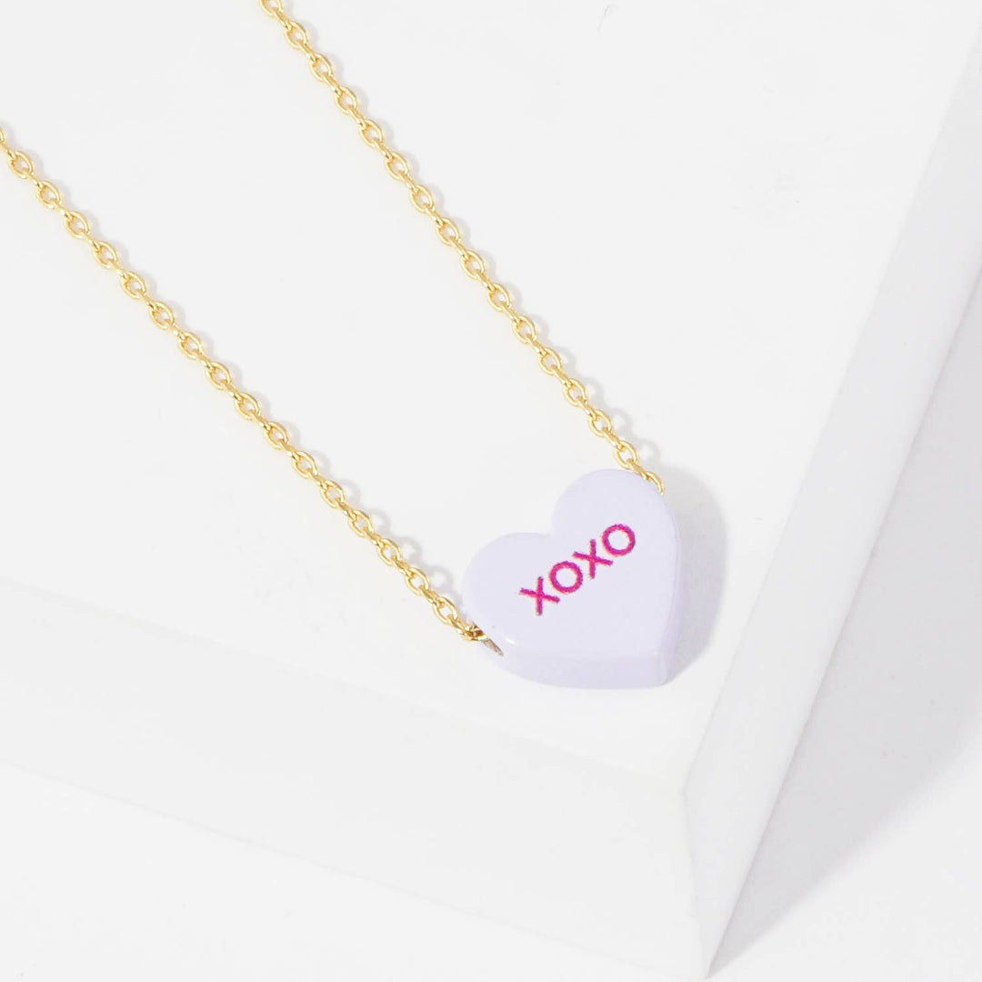 Gold Dipped Heart Candy Necklace layered in warm coastal boho style