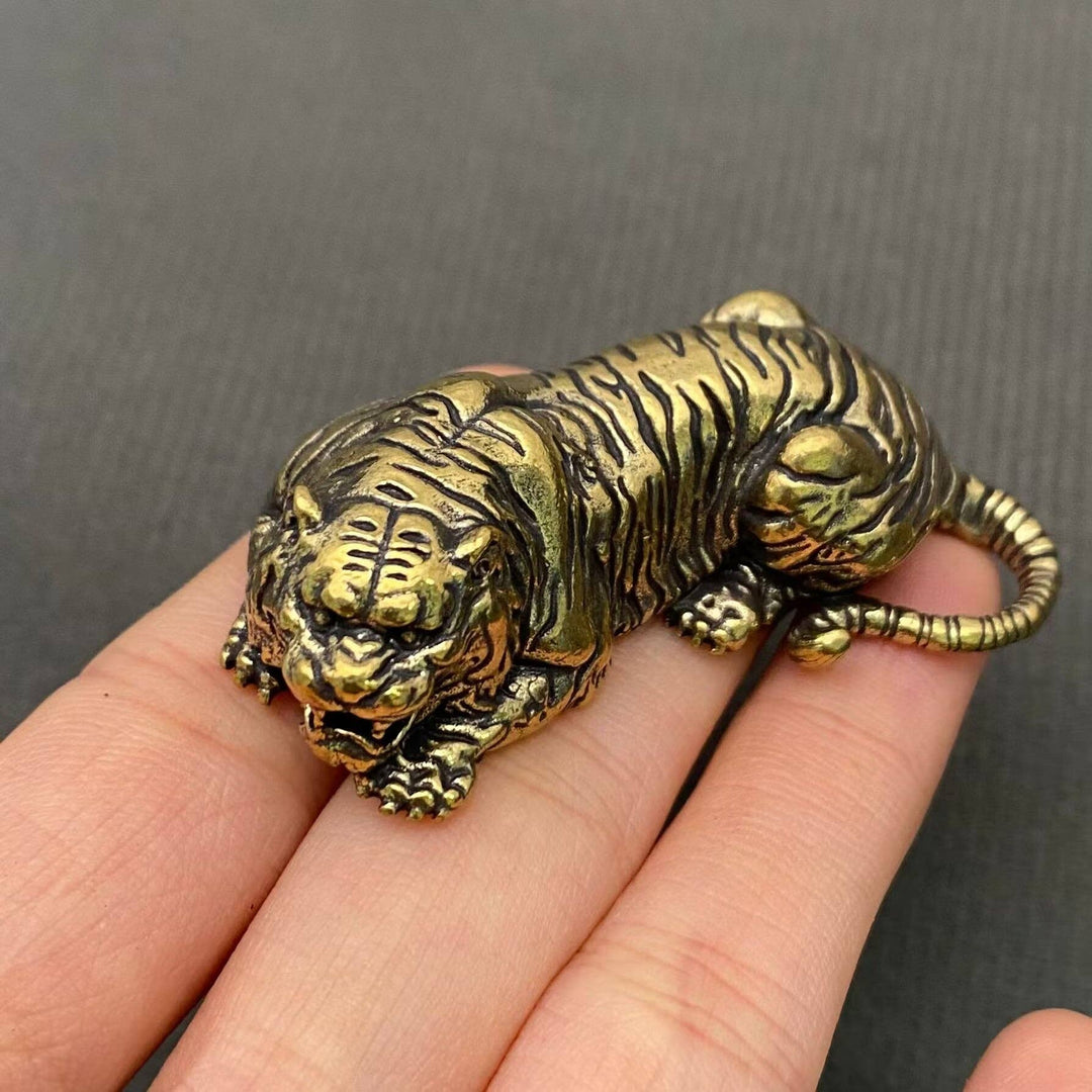 Handcrafted tiger brass desktop ornament radiating grounded power for intentional boho spaces