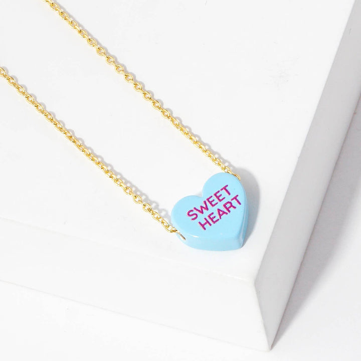 Gold Dipped Heart Candy Necklace layered with coastal boho charm and warmth