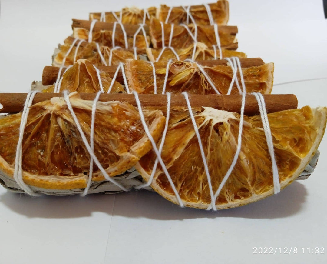Handcrafted orange slices and cinnamon with white sage bundle for coastal cleansing rituals