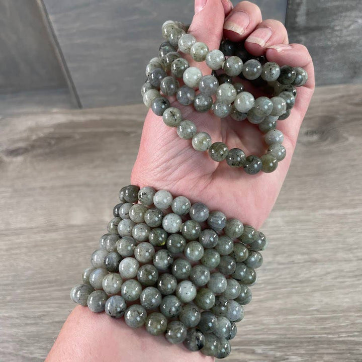 Healing crystal bracelets in rose quartz and amethyst for coastal boho style