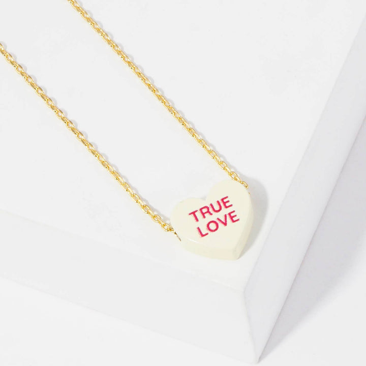 Gold Dipped Heart Candy Necklace layered in warm coastal boho style
