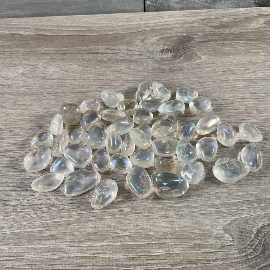 Angel Aura Quartz Tumbled Stones bulk bag glowing with rainbow iridescent shimmer