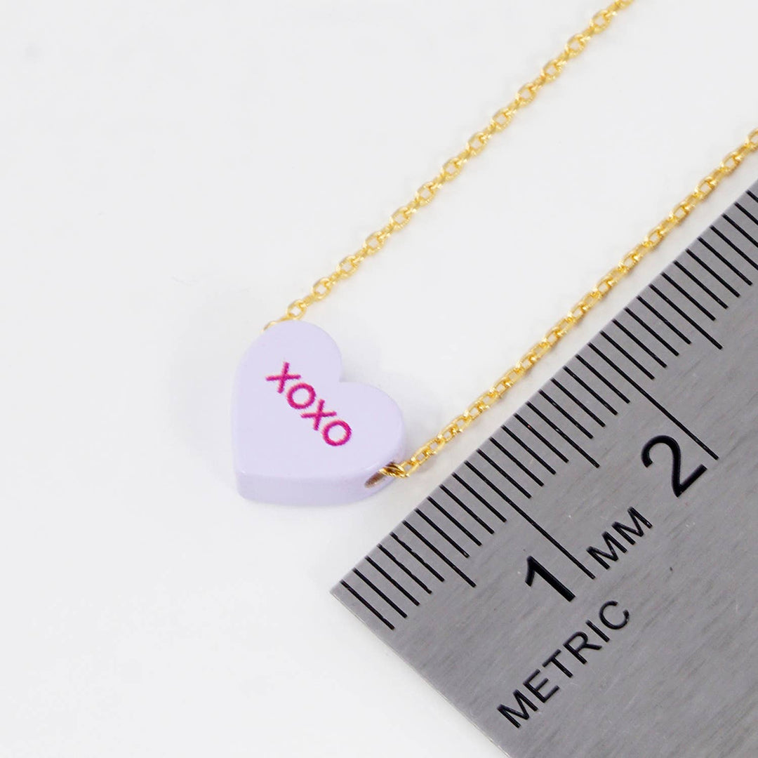 Gold Dipped Heart Candy Necklace layered in warm coastal boho style