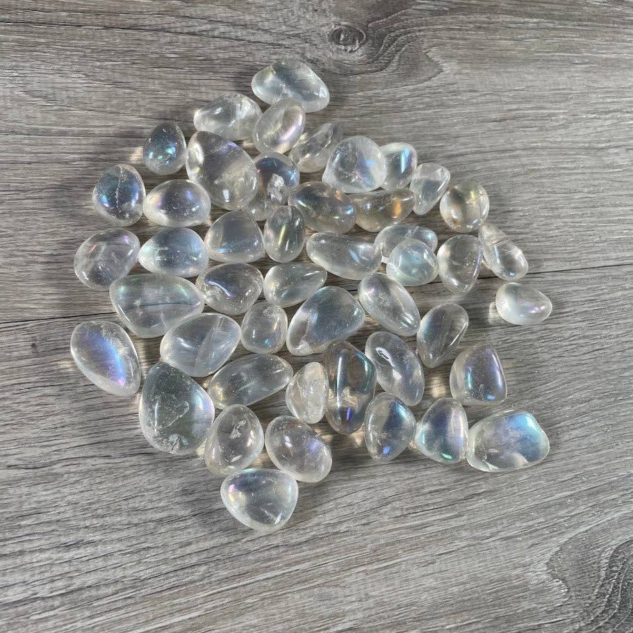 Angel Aura Quartz Tumbled Stones bulk bag glowing with iridescent rainbow crystal energy