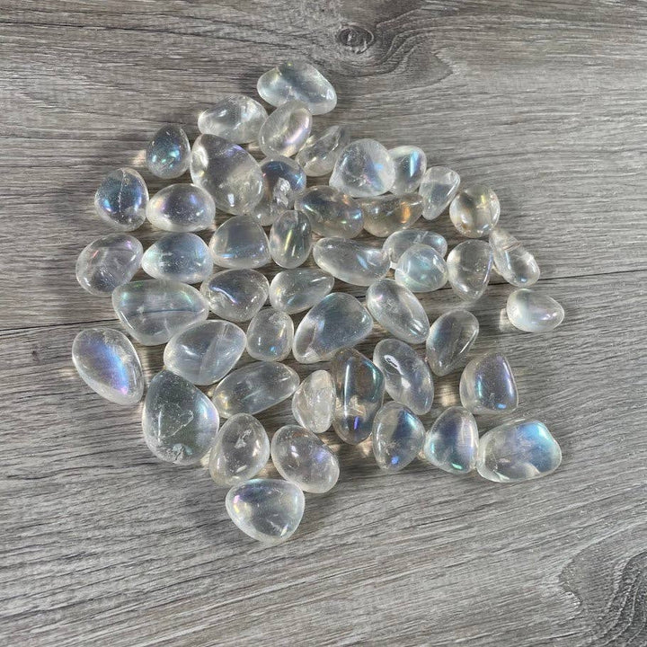 Angel Aura Quartz Tumbled Stones bulk bag glowing with iridescent rainbow crystal energy
