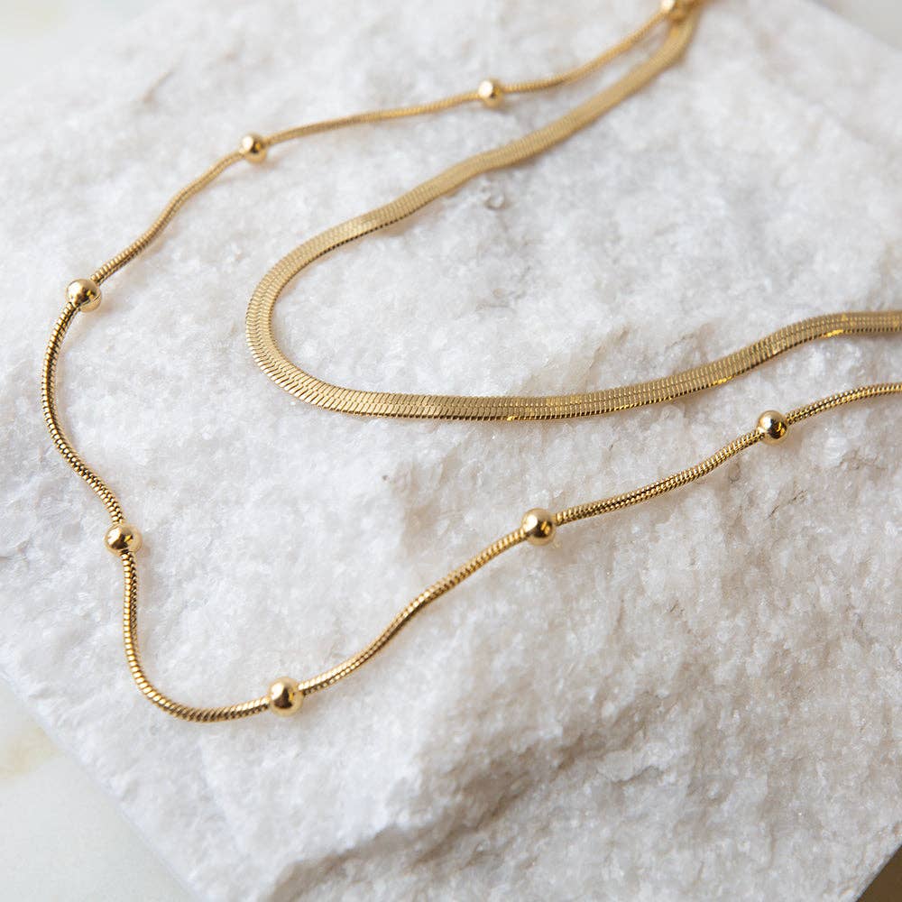 Gold chain layered necklace with herringbone and satellite chains for coastal boho style