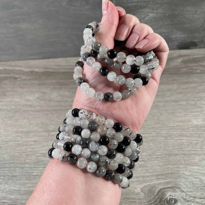Healing crystal bracelets in amethyst and rose quartz for coastal boho stacking
