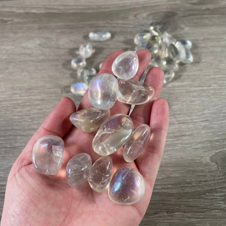 Angel Aura Quartz Tumbled Stones bulk bag glowing with rainbow iridescent healing energy