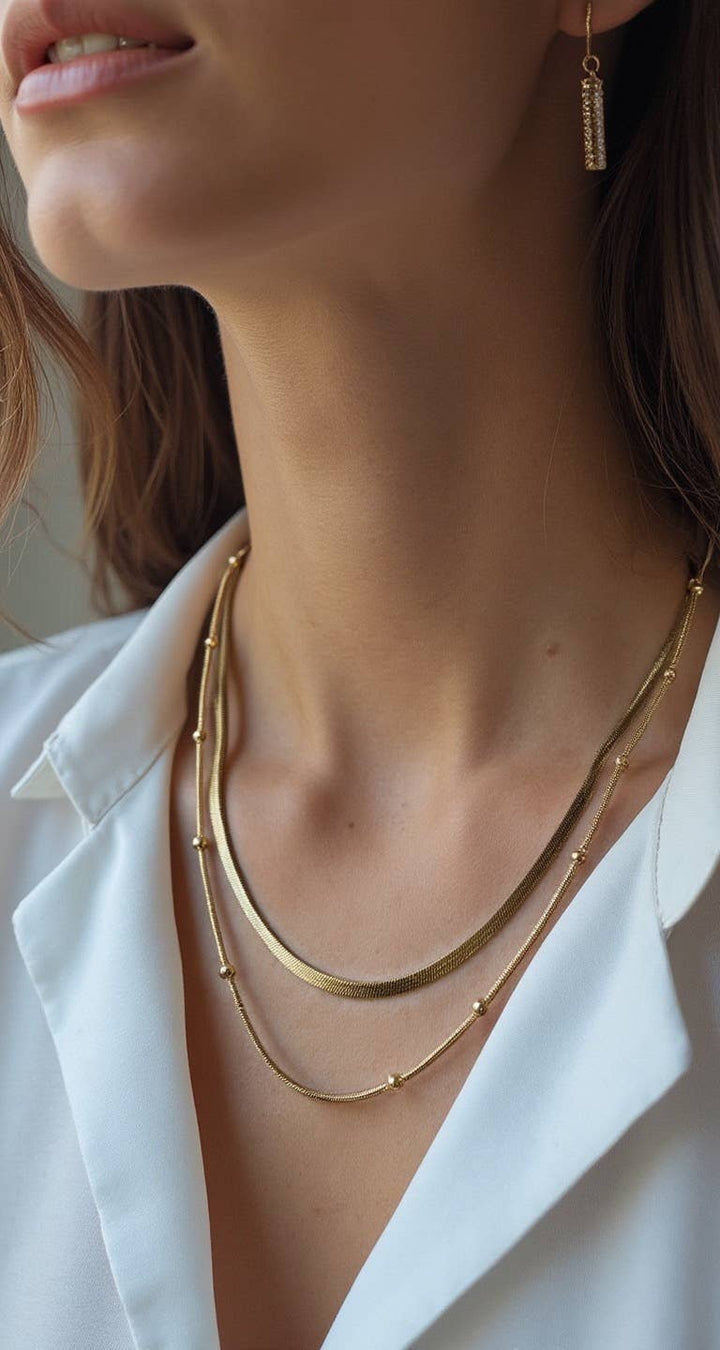 Gold chain layered necklace with herringbone and satellite chains for coastal boho style