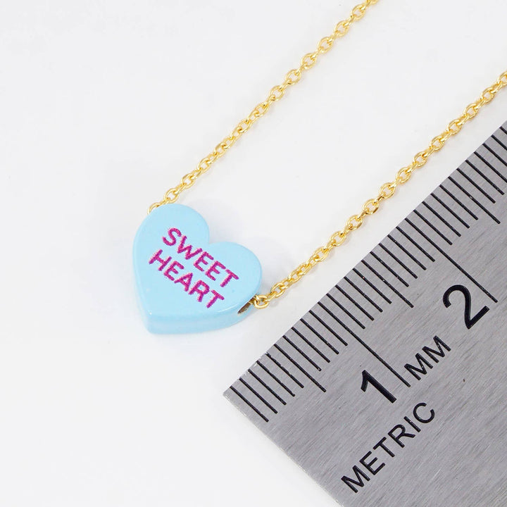 Gold Dipped Heart Candy Necklace layered in warm coastal boho style