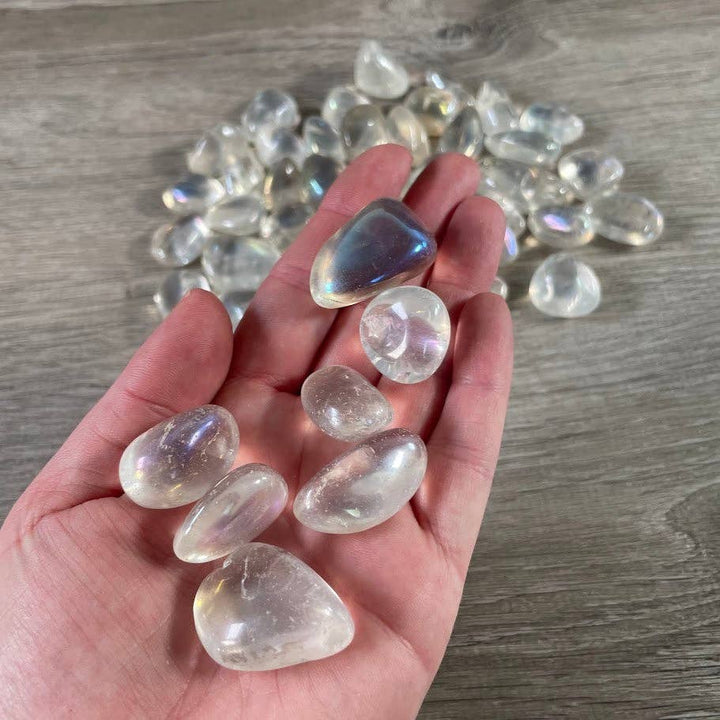Angel Aura Quartz Tumbled Stones bulk bag glowing with rainbow iridescent shimmer